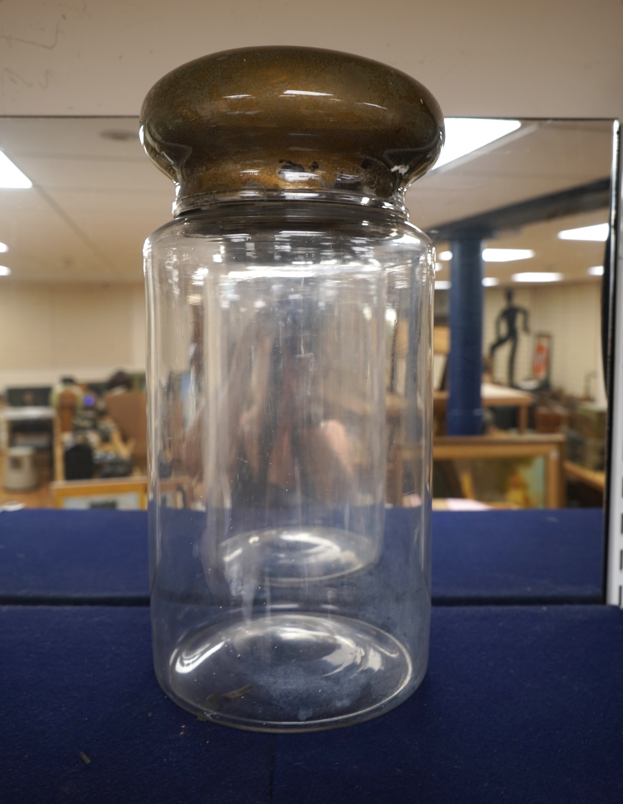 An 18th century cylindrical glass drug jar with remnants of gilding to the lid, 42cm high